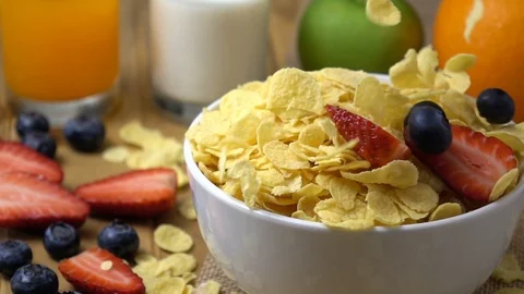 Strawberry and blueberry falling in to corn flakes splashing in slow motion. Stock Footage 94087272