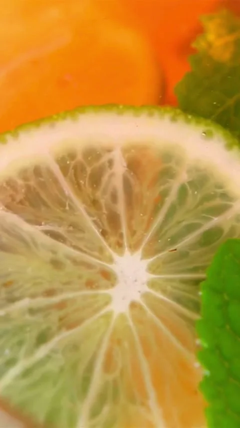 Strawberry and lime slices floating in fizzy lemonade drink Stock Footage 334169127