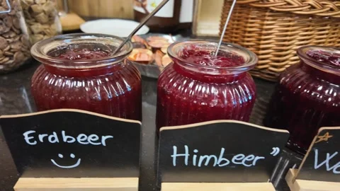 Strawberry and raspberry jam jars on hotel breakfast buffet Vídeo Stock 336313051
