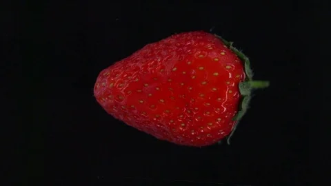Strawberry being squashed. Slow motion clip of the juices being extracted from a Stock Footage 83497608