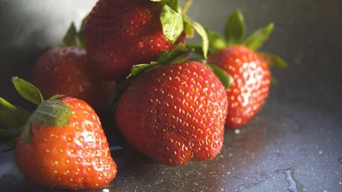 Strawberry berries close up on a dark background Stock Footage 124483306