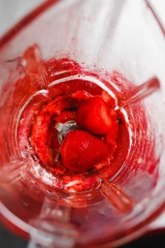 Strawberry in a blender top view Stock Photos