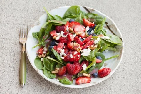 Strawberry blueberry walnut spinach salad top view Stock Photos