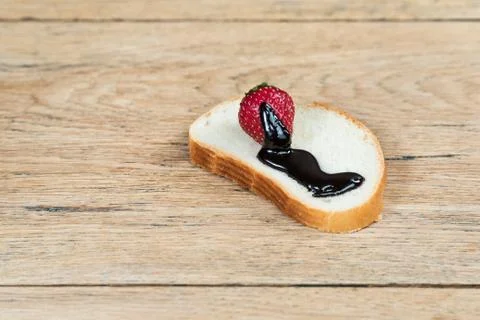 Strawberry on bread in chocolate Stock Photos