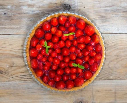 Strawberry cake with mint leaves on a rustic wood Stock Photos