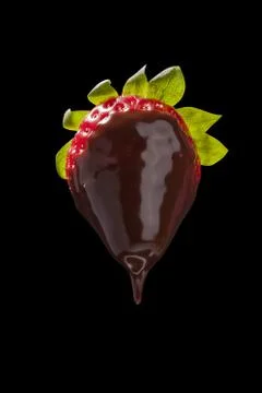 Strawberry in chocolate on black isolate Stock Photos