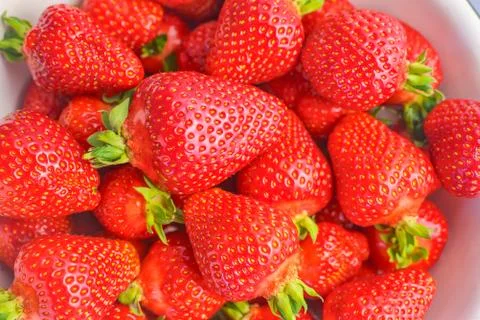 Strawberry closeup. Macro image of fresh strawberries on dark background Stock Photos