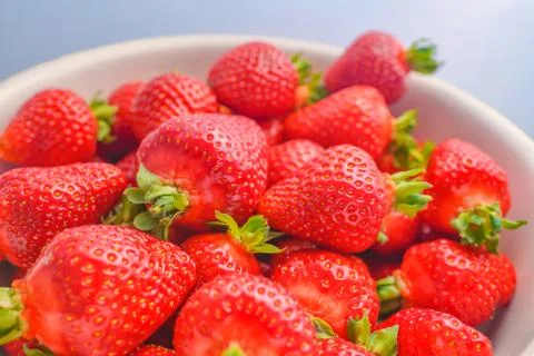Strawberry closeup. Macro image of fresh strawberries on dark background Stock Photos