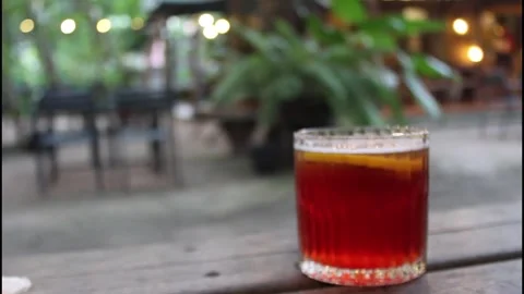Strawberry cocktail or mocktail with lemon slice on a wooden table Stock Footage 339244086