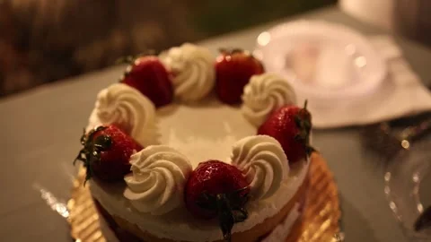 Strawberry cream cake on celebration table Stock Footage 337729091