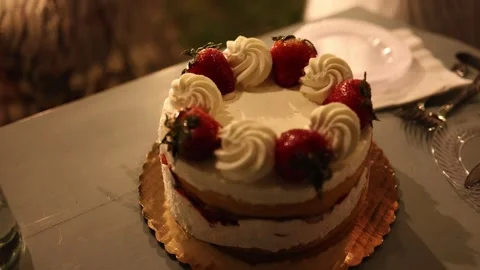 Strawberry cream cake on table Stock Footage 337795473