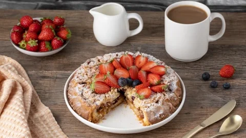 Strawberry Crumble Cake with Coffee on Rustic Table Stock Footage 346513924