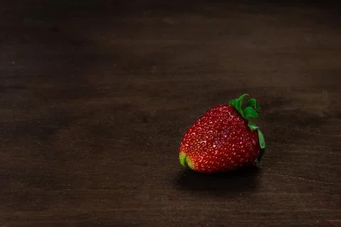 Strawberry on a dark wood background. Creative pattern concept. - Image 스톡 사진