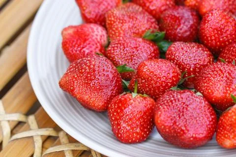 Strawberry in a disk on bamboo table Stock Photos