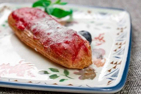 Strawberry Eclair with Glaze and Fresh Berries. Close-up Stock Photos