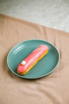 Strawberry Eclair served in plate isolated on napkin side view of cafe bake.. Foto stock