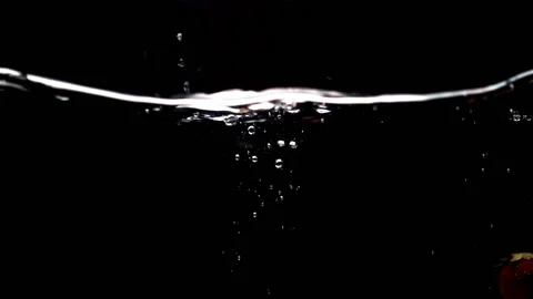 Strawberry fall into water in slow motion Stock Footage 148345601