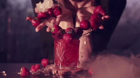 Strawberry Falling into a Cocktail Stock Footage 64767811