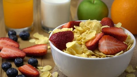 Strawberry falling in to corn flakes splashing in slow motion. Stock Footage 94086614