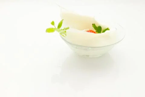 Strawberry falling into cream Stock Photos