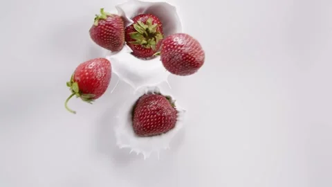 Strawberry falling into the milk and rotating Stock Footage 171887648