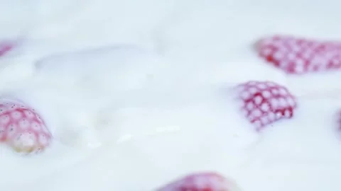 Strawberry Falling In Milk in a macro shot Stock Footage 250033311