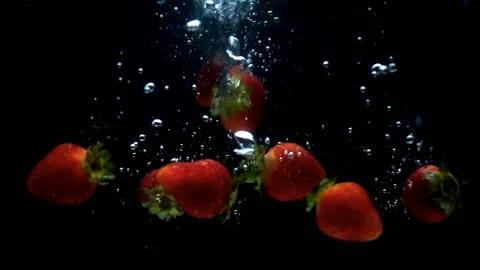 Strawberry falling into water in slow motion Stock Footage 142002905
