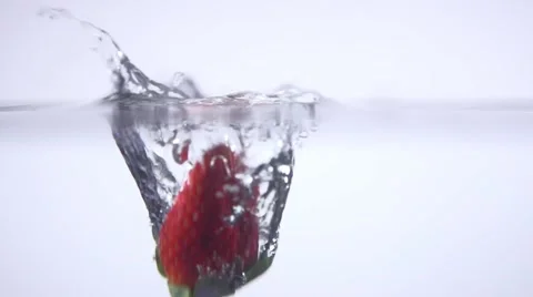 Strawberry falls into the water, slow motion Stock Footage 64748035