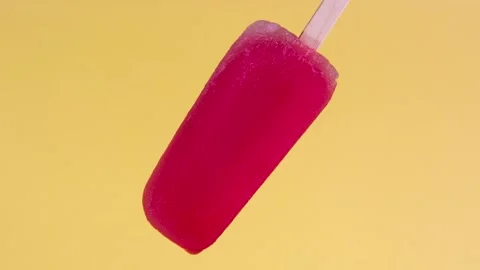 Strawberry flavored popsicle that melts quickly in time lapse Stock Footage 243711366