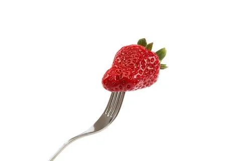 Strawberry on a fork isolated on white background. Stock Photos