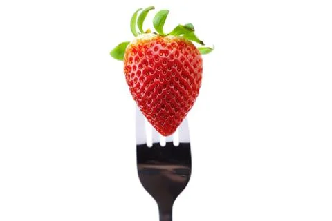 Strawberry on fork isolated on white Stock Photos