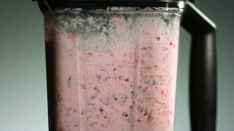 Strawberry fruit smoothie mixing inside a high speed blender Stock Footage 327576878