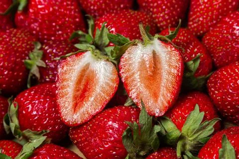 Strawberry full screen. Two halves of strawberries. Stock Photos