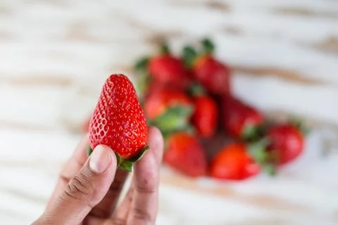 Strawberry in hand Foto stock