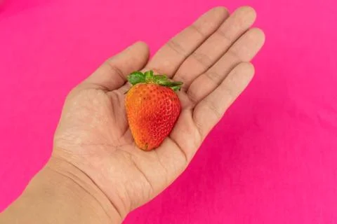 A strawberry in the hand Stock Photos