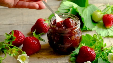 Strawberry jam in a jar. Selective focus. Video stock 156384250