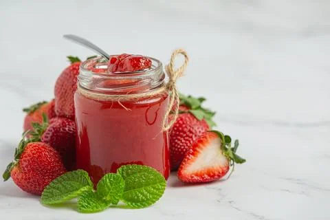 Strawberry jam on marble background Stock Photos