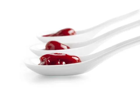 Strawberry jam in spoons Stock Photos