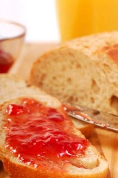 Strawberry jam spread on bread Stock Photos