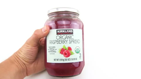 Strawberry jam spread preserve bottle glass jar by Kirkland signature Costco Stock Footage 231600862