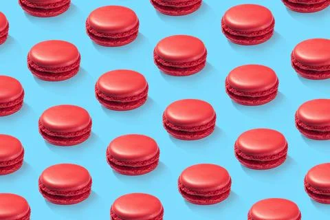 Strawberry macarons pattern on blue background isolated Stock Photos