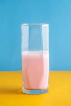 Strawberry milkshake on a colored background Stock Photos