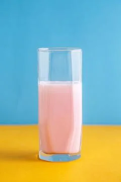Strawberry milkshake on a colored background Stock Photos