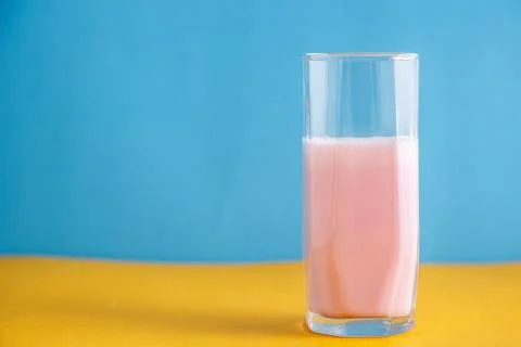 Strawberry milkshake on a colored background Stock Photos