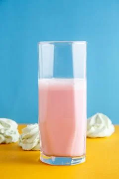 Strawberry milkshake on a colored background Stock Photos