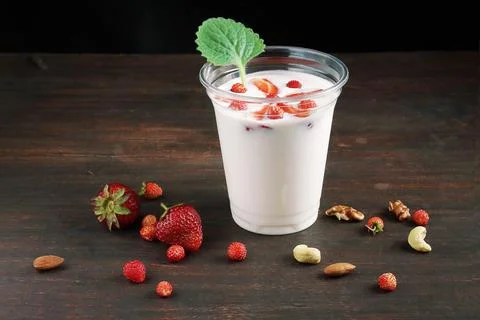 Strawberry milkshake over rustic background 写真素材