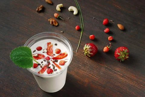 Strawberry milkshake over rustic background Stock Photos