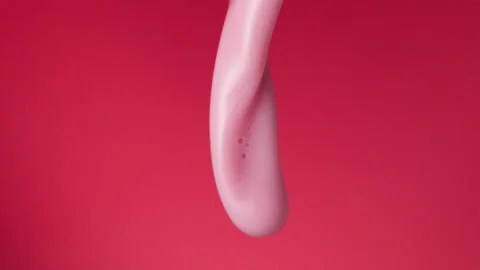 Strawberry milkshake pouring over flat background Stock Footage 149003934