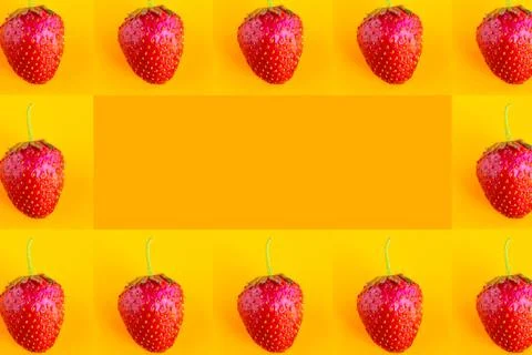 Strawberry pattern on bright orange background, copy space for the text Stockfoto's