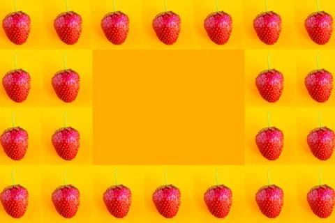 Strawberry pattern on bright orange background, copy space for the text Stock Photos